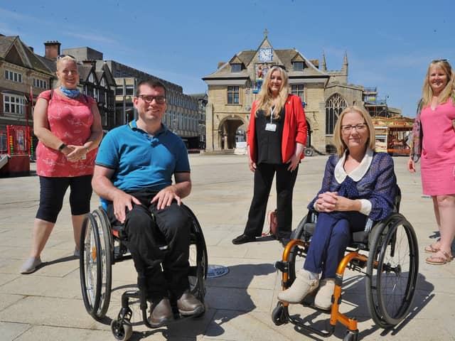 Disabled access campaigners Graham Barnes (front left) and Julie Fernandez (front right), pictured in Cathedral Square in 2021.