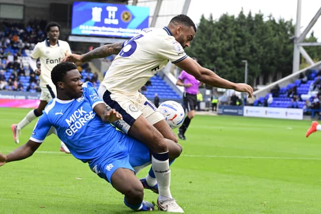 Bolu Shofowoke of Posh battles with Curtis Tilt of Burton Albion. Photo David Lowndes.