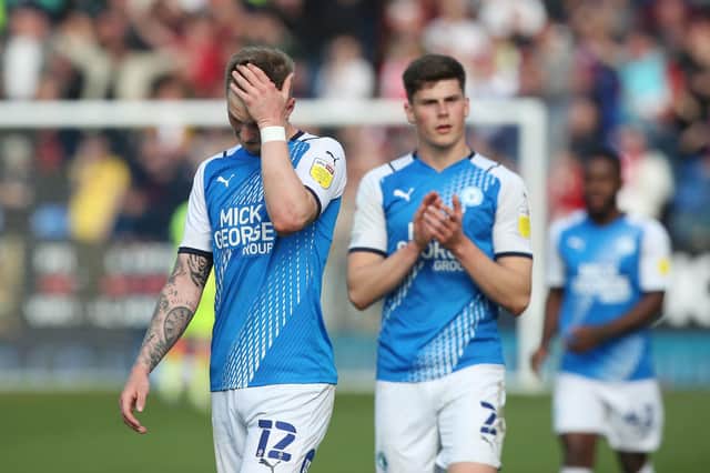 Josh Knight of Peterborough United cuts a dejected figure at full-time as relegation is confirmed