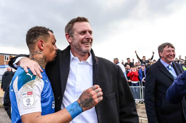 Posh chairman Darragh MacAnthony celebrates promotion from League One with striker Jonson Clarke-Harris at the end of the 2020-21 season. Photo: David Lowndes.