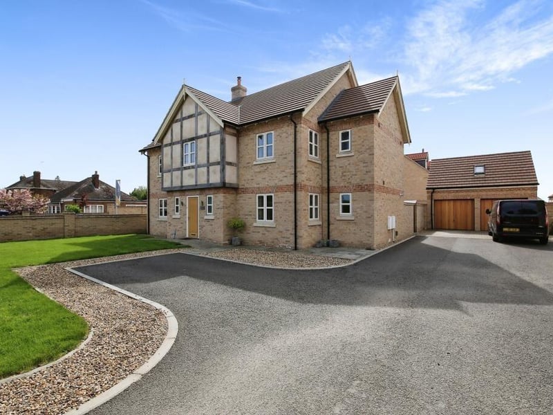 A view of the front of the house, driveway and double garage