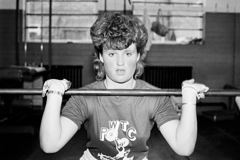 A woman uses weights to do squats at Pauly's gym on Lincoln Road July 16, 1985.