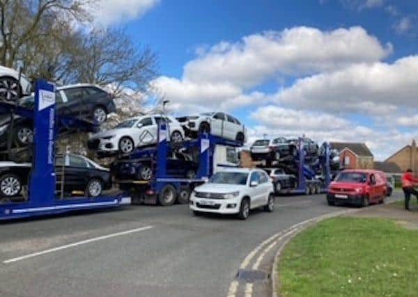 Car transporters queue in Dunblane Drive, Peterborough, on their way to the East of England Showground.