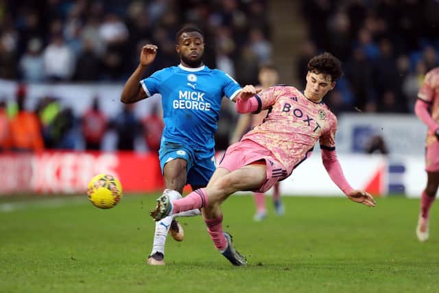 David Ajiboye of Peterborough United is tackled by Archie Gray of Leeds United. Photo: Joe Dent/theposh.com.