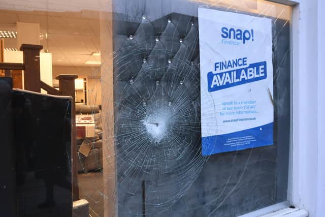 Smashed windows at Furniture on Budget in Rivergate.