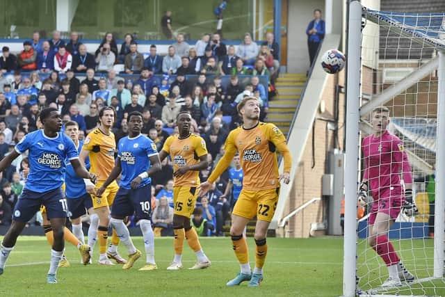 Cambridge United defender Lloyd Jones has just headed into his own net at London Road in October. Photo: David Lowndes.