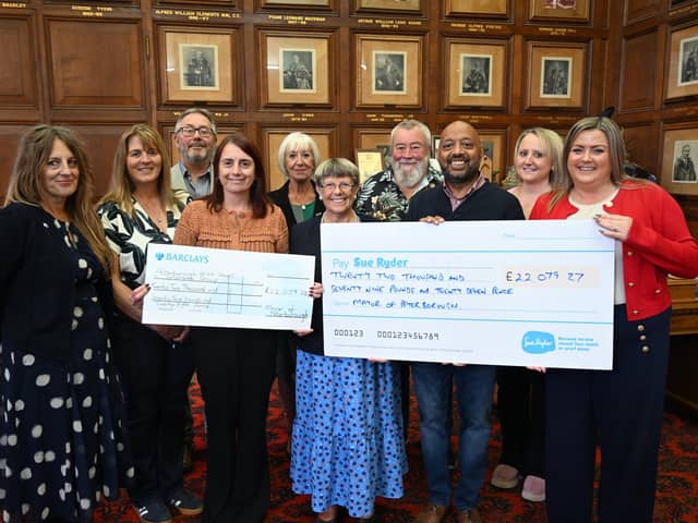 Cllr Judy Fox hands over her Mayor's Charity cheques to representatives from the Peterborough Area Down's Syndrome Group and Sue Ryder at the Town Hall.