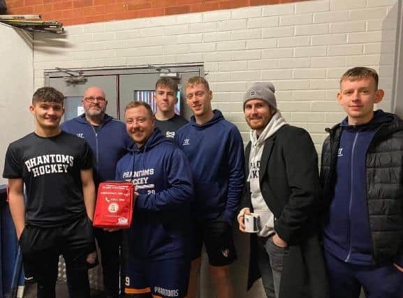 Peterborough captain Will Weldon holds the kit, alongside other members of the Phantoms squad