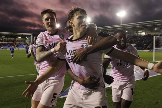 Hector Kyprianou of Peterborough United celebrates scoring the winning goal with team-mates. Photo: Joe Dent.