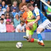 Josh Knight of Peterborough United in action with Jack Colback of Nottingham Forest.