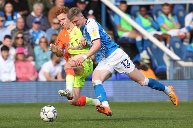 Josh Knight of Peterborough United in action with Jack Colback of Nottingham Forest.