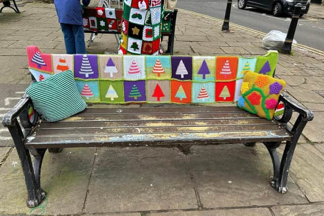 More than 1,500 squares of knitted material now cover seven benches and two trees within the town centre.