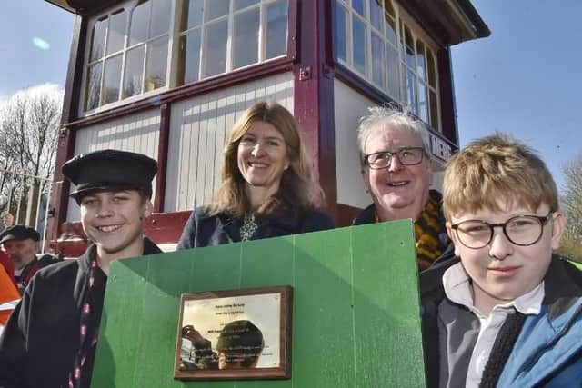Teenage train fans and dedicated fundraisers Harry Cowley (left) and Oliver Walker with NVR president Miranda Rock and chairman Michael Purcell at the signal box reopening ceremony.
