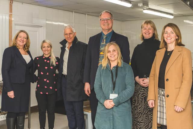 Allison Homes and its partners receive a tour of the newly refurbished community kitchen at the Ferry Project in Wisbech.