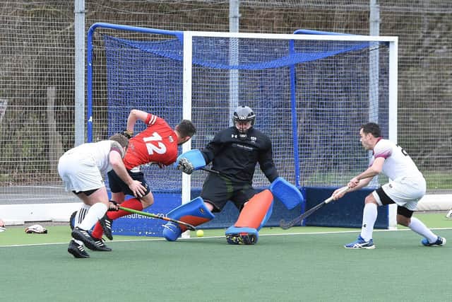 Hockey action from City of Peterborough (red) v Bedford. Photo: David Lowndes.