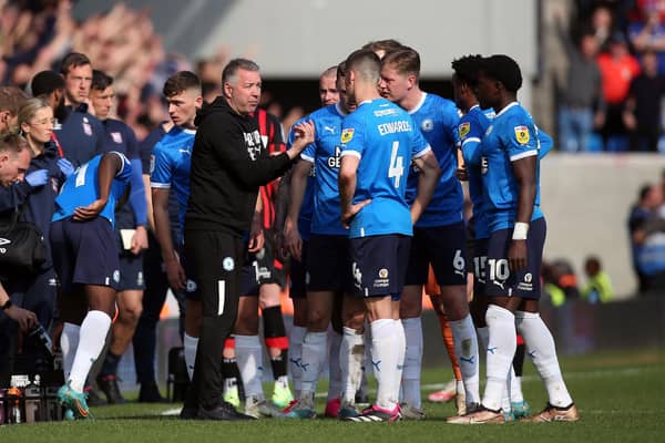 Peterborough United manager Darren Ferguson talks to his players during a break in play
