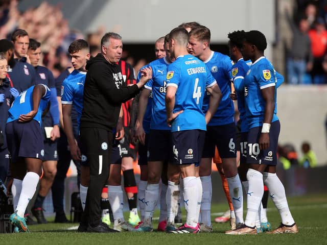 Peterborough United manager Darren Ferguson talks to his players during a break in play