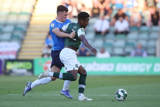 Charlie O'Connell of Peterborough United battles with Niall Ennis of Plymouth Argyle. Photo: Joe Dent/theposh.com