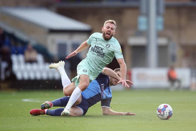 Dan Butler of Peterborough United is fouled by Sam Vokes of Wycombe Wanderers. Photo: Joe Dent/theposh.com.