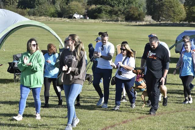 Members from the various fundraising teams took it in turns to walk around the course for 12 straight hours. .