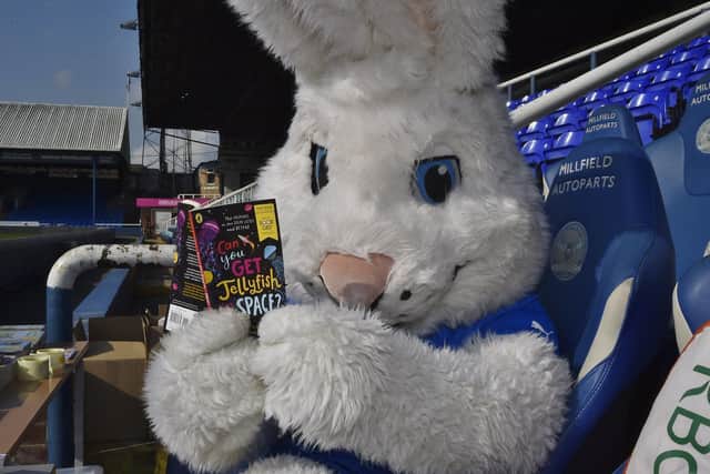 Posh mascot Peter Burrow taking time out to enjoy a read during World Book Day celebrations at Weston Homes Stadium
