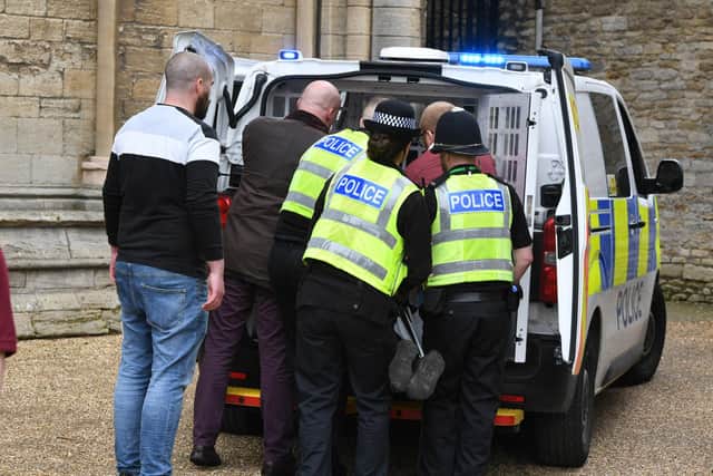 Police arrest a man at the party