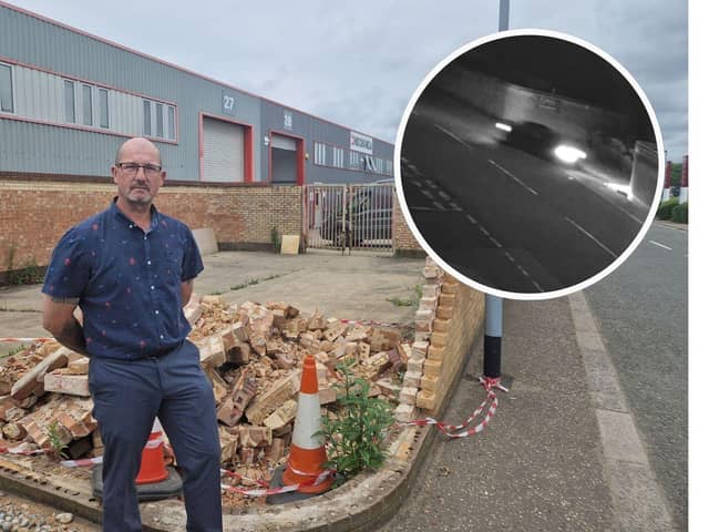 Warehouse manager Steve Butler, next to the wall which was destroyed by a car drifting on Tresham Road (inset)