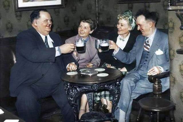 Laurel and Hardy, enjoying a good old-fashioned British pint with their wives, on their 1952 UK theatre tour.