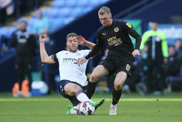 Dion Charles (white) in action for Bolton v Posh last season. Photo: Joe Dent/theposh.com.