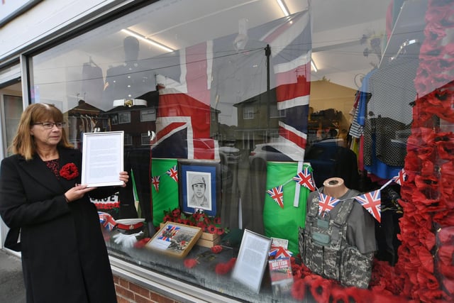 Jacqui Murphy, mother of Cpl Lee Fitzsimmons in front of the window display for which she has donated a number of Lee's possessions.