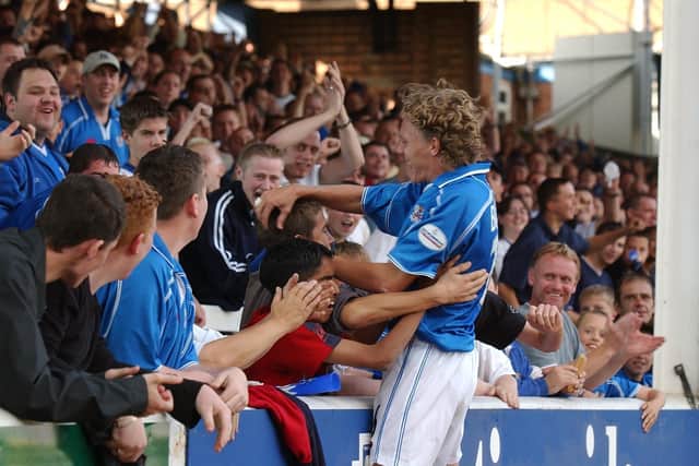 Jimmy Bullard celebrates a goal for Posh with the club's fans. Photo: Adam Fairbrother.