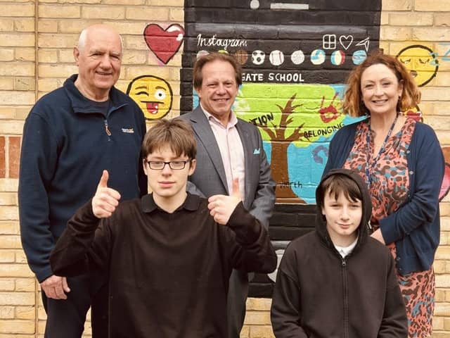 Rogerio Antunes (Immediate Past Master) and David Hilton (Charity Steward) meet school students Archie and Brandon who will directly benefit from the donation.