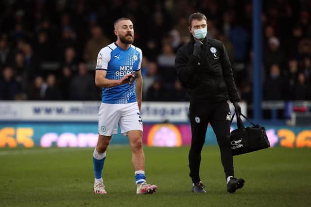 Dan Butler limps off with an injury last December. Photo: Joe Dent/theposh.com