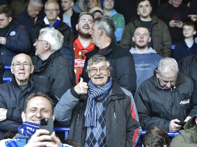 Peterborough United fans are pictured watching the crucial win over Derby County.