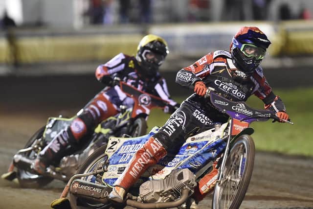 Heat 5  action from Panthers v Belle Vue involving home riders Hans Andersen (red helmet) and  Benjamin Basso (blue).