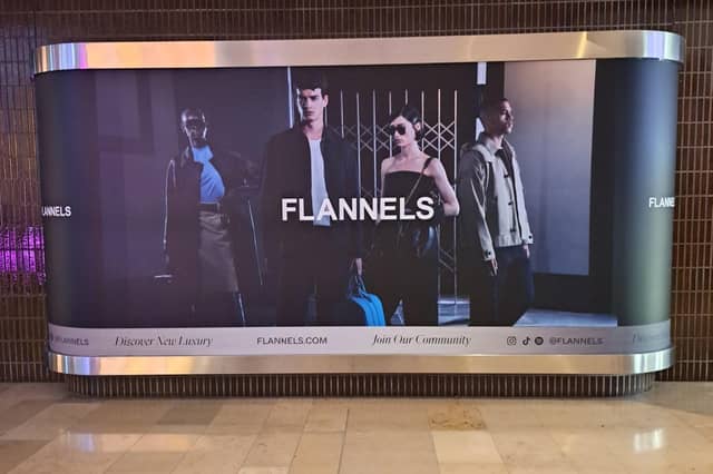 New signage at Peterborough's Queensgate Shopping Centre show that Flannels, a clothing brand owned by the Frasers Group, is on its way to the city.