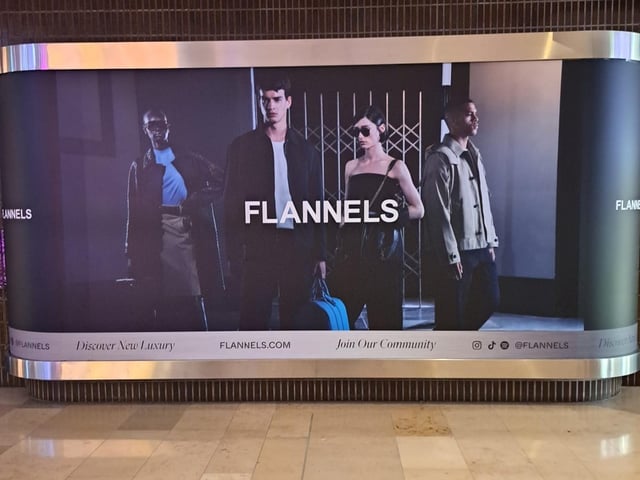 New signage at Peterborough's Queensgate Shopping Centre show that Flannels, a clothing brand owned by the Frasers Group, is on its way to the city.