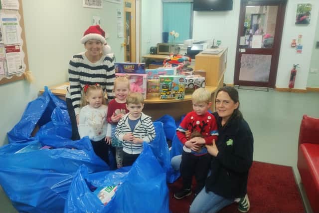 Staff and children from Cygnets Pre School, Hampton Children and Family Centre, Peterborough, with the toys donated by Hotpoint staff