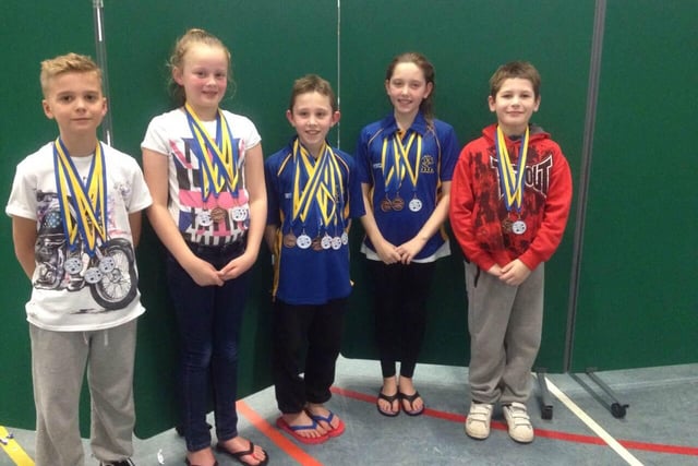 Five youngsters from Mansfield Swimming Club show off a haul of medals.