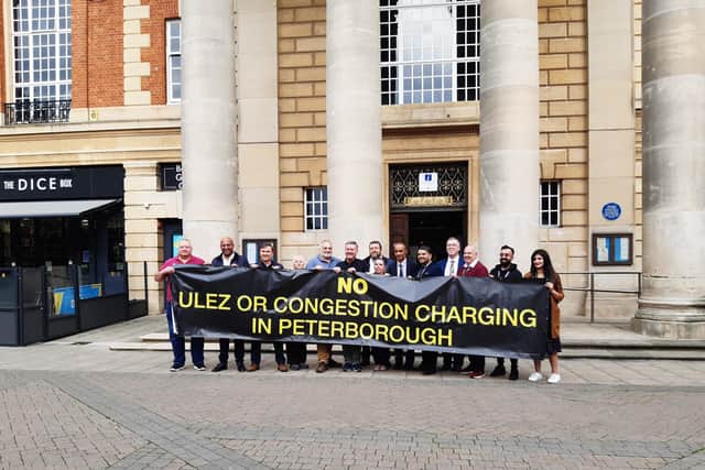 Councillors met outside Peterborough's Town Hall to signal their opposition to congestion charging - and claims they want to introduce it
