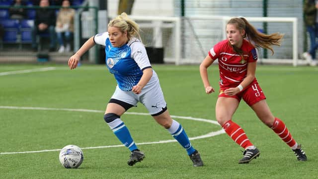 Cassie Steward (blue) opened the scoring for Posh at Wem.