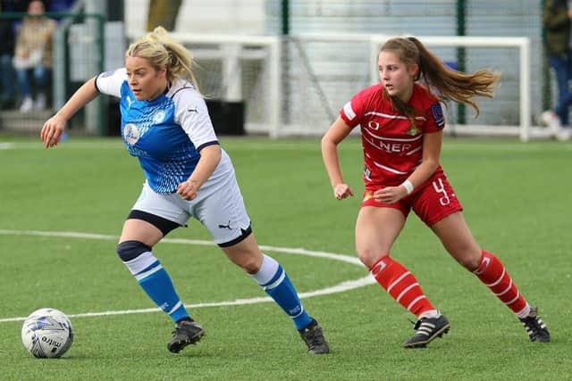 Cassie Steward (blue) opened the scoring for Posh at Wem.