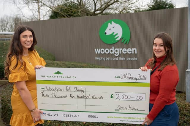 BN - SGB-32514 - Alyse of Barratt Homes (L) handing the cheque to Amy of Woodgreen