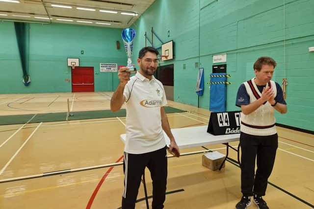 ​AK 11 skipper Mohammad Zahid Nadeem with the indoor trophy. Also pictured is competition organiser Jonathan Bigham.