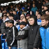 Peterborough United fans watch the defeat to Wigan Athletic.