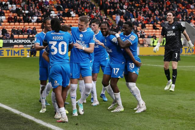 Peterborough United players celebrate during the Sky Bet League 1 match between Blackpool and Peterborough at Bloomfield Road. Photo: Joe Dent.