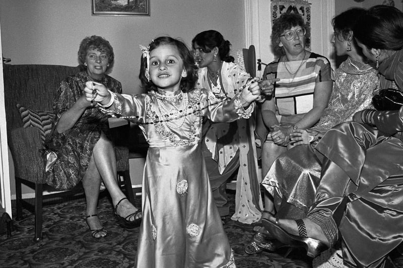 A girl dances as members of the Goulistan Girls Group meet others for tea as part of a cultural exchange initiative in Peterborough, 1985.