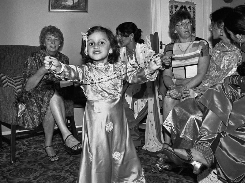 A girl dances as members of the Goulistan Girls Group meet others for tea as part of a cultural exchange initiative in Peterborough, 1985.