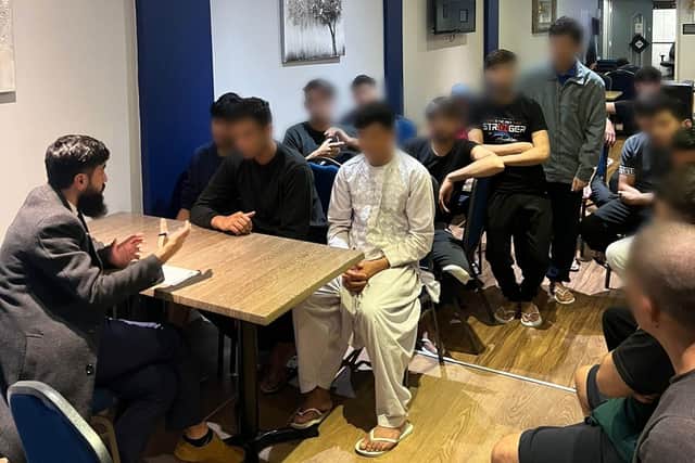 Some of the asylum seekers placed at the Great Northern Hotel in Peterborough get a chance to talk about their escape to safety and their medical and other essential needs to members of the United Afghan Community Association of Peterborough.