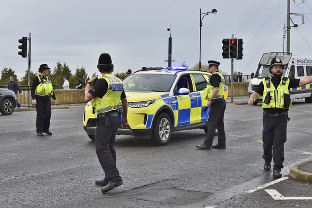 Police and football fans on Town Bridge outside the stadium and Charters before the Cambridgeshire derby